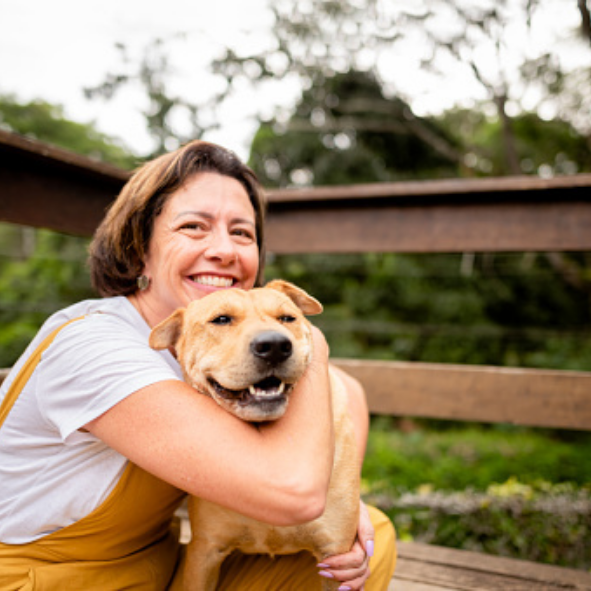 Maria, 45 year old who used kevahealth during wildfire, posing with her dog.